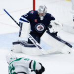 May 15, 2025; Winnipeg, Manitoba, CAN; Winnipeg Jets goalie Connor Hellebuyck (37) makes a save on a shot by Dallas Stars forward Mikko Rantanen (96) during the third period in game five of the second round of the 2025 Stanley Cup Playoffs at Canada Life Centre. Mandatory Credit: Terrence Lee-Imagn Images