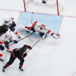 May 20, 2025; Raleigh, North Carolina, USA; Florida Panthers goaltender Sergei Bobrovsky (72) reaches for the puck against Carolina Hurricanes forward Jordan Staal (11) during the second period in game one of the Eastern Conference Final of the 2025 Stanley Cup Playoffs at Lenovo Center. Mandatory Credit: James Guillory-Imagn Images