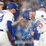 May 20, 2025; Los Angeles, California, USA; Los Angeles Dodgers third baseman Max Muncy (13) celebrates with right fielder Andy Pages (44) after hitting a sacrifice fly in the 10th inning against the Arizona Diamondbacks at Dodger Stadium. Mandatory Credit: Kirby Lee-Imagn Images