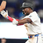 May 6, 2025; Miami, Florida, USA; Miami Marlins right fielder Jesús Sánchez, right, celebrates his walk-off single in the tenth inning with third baseman Connor Norby against the Los Angeles Dodgers at loanDepot Park.