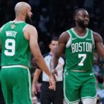 Oct 22, 2024; Boston, Massachusetts, USA; Boston Celtics guard Jaylen Brown (7), guard Jrue Holiday (4) and guard Derrick White (9) react after a play against the New York Knicks in the second half at TD Garden.