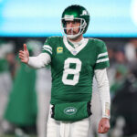 Jan 5, 2025; East Rutherford, New Jersey, USA; New York Jets quarterback Aaron Rodgers (8) gestures towards the Miami Dolphins bench during the second half at MetLife Stadium. Mandatory Credit: Vincent Carchietta-Imagn Images