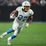 Jan 5, 2025; Paradise, Nevada, USA; Los Angeles Chargers running back JK Dobbins (27) carries the ball against the Las Vegas Raiders in the second half at Allegiant Stadium. Mandatory Credit: Kirby Lee-Imagn Images
