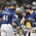 May 16, 2025; San Diego, California, USA; Seattle Mariners catcher Cal Raleigh (29) is congratulated by Julio Rodriguez (44) after hitting a two-run home run during sixth inning against the San Diego Padres at Petco Park. Mandatory Credit: Denis Poroy-Imagn Images