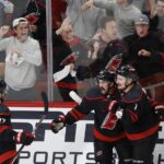 May 28, 2025; Raleigh, North Carolina, USA; Carolina Hurricanes forward Seth Jarvis (24) celebrates scoring with forward Andrei Svechnikov (37) and defenseman Dmitry Orlov (7) during the third period against the Florida Panthers in game five of the Eastern Conference Final of the 2025 Stanley Cup Playoffs at Lenovo Center. Mandatory Credit: Geoff Burke-Imagn Images