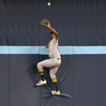 May 30, 2025; Toronto, Ontario, CAN; Athletics center fielder Denzel Clarke (1) climbs the outfield wall to catch a fly ball hit by Toronto Blue Jays catcher Alejandro Kirk (not shown) in the fifth inning at Rogers Centre. Mandatory Credit: Dan Hamilton-Imagn Images