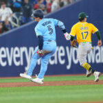 May 31, 2025; Toronto, Ontario, CAN; Toronto Blue Jays centre fielder Daulton Varsho (5) grabs his left leg after rounding second base against the Athletics during the third inning at Rogers Centre. Mandatory Credit: Nick Turchiaro-Imagn Images