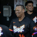 Jun 17, 2025; San Francisco, California, USA; San Francisco Giants designated hitter Rafael Devers (16) greets his new teammates in the dugout before taking on the Cleveland Guardians during the first inning at Oracle Park. Mandatory Credit: D. Ross Cameron-Imagn Images