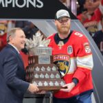 Jun 17, 2025; Sunrise, Florida, USA; Gary Bettman, NHL Commissioner, presents Florida Panthers center Sam Bennett (9) the Conn Smythe Trophy after winning game six of the 2025 Stanley Cup Final against the Edmonton Oilers at Amerant Bank Arena. Mandatory Credit: Sam Navarro-Imagn Images