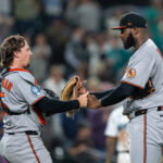 Jun 4, 2025; Seattle, Washington, USA; Balitimore Orioles catcher Adley Rutschman (35), left, and relief pitcher Felix Bautista (74) celebrate after a game against the Seattle Mariners at T-Mobile Park.
