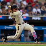 Jul 29, 2025; Minneapolis, Minnesota, USA; Minnesota Twins center fielder Harrison Bader (12) hits a single during the fifth inning against the Boston Red Sox at Target Field