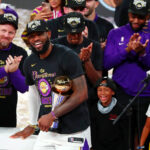 Oct 11, 2020; Lake Buena Vista, Florida, USA; Los Angeles Lakers forward LeBron James (23) smiles while holding the MVP trophy after game six of the 2020 NBA Finals at AdventHealth Arena. The Los Angeles Lakers won 106-93 to win the series.
