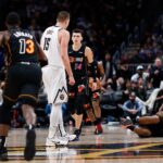 Nov 8, 2021; Denver, Colorado, USA; Miami Heat forward Markieff Morris (8) lies on the ground after a play with Denver Nuggets center Nikola Jokic (15) as guard Tyler Herro (14) and center Bam Adebayo (13) react in the fourth quarter at Ball Arena.