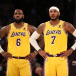 Nov 26, 2021; Los Angeles, California, USA; Los Angeles Lakers forward LeBron James (6) and forward Carmelo Anthony (7) stand on the court during the game against the Sacramento Kings at Staples Center. The Kings wins 141-137 in the triple-overtime. Mandatory Credit: Kiyoshi Mio-USA TODAY Sports