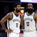 Feb 2, 2022; Sacramento, California, USA; Brooklyn Nets guard Kyrie Irving (11) and guard James Harden (13) talk during the fourth quarter against the Sacramento Kings at Golden 1 Center. Mandatory Credit: Sergio Estrada-Imagn Images