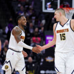 Feb 24, 2022; Sacramento, California, USA; Denver Nuggets forward Will Barton (5) and center Nikola Jokic (15) shake hands during the third quarter against the Sacramento Kings at Golden 1 Center.