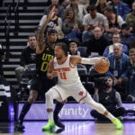 Nov 15, 2022; Salt Lake City, Utah, USA; New York Knicks guard Jalen Brunson (11) protects the ball from Utah Jazz guard Jordan Clarkson (00) during the second half at Vivint Arena.