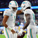 Dec 11, 2022; Inglewood, California, USA; Miami Dolphins wide receiver Tyreek Hill (10) celebrates his touchdown scored against the Los Angeles Chargers with quarterback Tua Tagovailoa (1) during the first half at SoFi Stadium. Mandatory Credit: Gary A. Vasquez-USA TODAY Sports