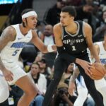 Jan 31, 2024; San Antonio, Texas, USA; San Antonio Spurs center Victor Wembanyama (1) looks to pass in front of Orlando Magic forward Paolo Banchero (5) in the second half at Frost Bank Center. Mandatory Credit: Daniel Dunn-USA TODAY Sports