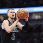 Feb 22, 2024; Chicago, Illinois, USA; Boston Celtics center Kristaps Porzingis (8) shoots a free throw against the Chicago Bulls during the second half at United Center. Mandatory Credit: Kamil Krzaczynski-USA TODAY Sports