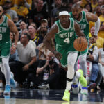 May 25, 2024; Indianapolis, Indiana, USA; Boston Celtics guard Jrue Holiday (4) brings the bal up court with guard Derrick White (9) and forward Xavier Tillman (26) against the Indiana Pacers during the third quarter of game three of the eastern conference finals in the 2024 NBA playoffs at Gainbridge Fieldhouse.