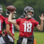 Jun 3, 2024; Atlanta, GA, USA; Atlanta Falcons quarterback Kirk Cousins (18) throws while quarterback Michael Penix Jr (9) watches on the field during Falcons OTA at the Falcons Training facility. Mandatory Credit: Dale Zanine-USA TODAY Sports