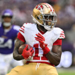 Sep 15, 2024; Minneapolis, Minnesota, USA; San Francisco 49ers wide receiver Brandon Aiyuk (11) looks for yards after the catch against the Minnesota Vikings during the first quarter U.S. Bank Stadium. Mandatory Credit: Jeffrey Becker-Imagn Images