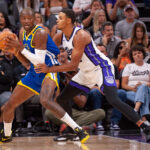Oct 9, 2024; Sacramento, California, USA; Sacramento Kings forward Keegan Murray (13) defends against Golden State Warriors forward Jonathan Kuminga (00) during the first quarter at Golden 1 Center.
