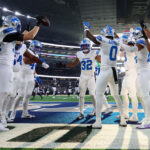 Oct 13, 2024; Arlington, Texas, USA; Detroit Lions safety Brian Branch (32) celebrates with teammates after making an interception during the second half against the Dallas Cowboys at AT&T Stadium. Mandatory Credit: Kevin Jairaj-Imagn Images
