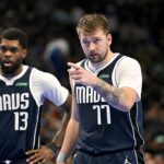 Nov 19, 2024; Dallas, Texas, USA; Dallas Mavericks guard Luka Doncic (77) motions to his teammates as forward Naji Marshall (13) looks on during the second half against the New Orleans Pelicans at the American Airlines Center.