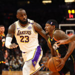 Nov 26, 2024; Phoenix, Arizona, USA; Los Angeles Lakers forward LeBron James (23) defends against Phoenix Suns guard Bradley Beal (3) during an NBA Cup game at Footprint Center.