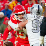 Nov 29, 2024; Kansas City, Missouri, USA; Kansas City Chiefs quarterback Patrick Mahomes (15) is sacked by Las Vegas Raiders defensive end Maxx Crosby (98) during the second half at GEHA Field at Arrowhead Stadium. Mandatory Credit: Denny Medley-Imagn Images