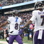 Dec 15, 2024; East Rutherford, New Jersey, USA; Baltimore Ravens quarterback Lamar Jackson (8) and wide receiver Rashod Bateman (7) celebrates after a touchdown pass during the first half against the New York Giants at MetLife Stadium. Mandatory Credit: Vincent Carchietta-Imagn Images