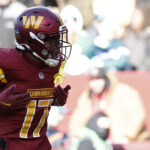 Dec 22, 2024; Landover, Maryland, USA; Washington Commanders wide receiver Terry McLaurin (17) celebrates after catching a touchdown pass against the Philadelphia Eagles during the second quarter at Northwest Stadium. Mandatory Credit: Geoff Burke-Imagn Images