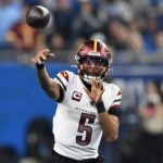 Jan 18, 2025; Detroit, Michigan, USA; Washington Commanders quarterback Jayden Daniels (5) throws a pass during the first quarter against Detroit Lions in a 2025 NFC divisional round game at Ford Field. Mandatory Credit: Lon Horwedel-Imagn Images