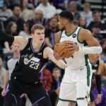 Jan 27, 2025; Salt Lake City, Utah, USA; Milwaukee Bucks forward Giannis Antetokounmpo (34) keeps the ball away from Utah Jazz forward Lauri Markkanen (23) during the second half at Delta Center.