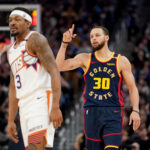 Jan 31, 2025; San Francisco, California, USA; Golden State Warriors guard Stephen Curry (30) reacts after making a three point basket next to Phoenix Suns guard Bradley Beal (3) in the fourth quarter at the Chase Center.