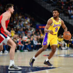 Feb 4, 2025; Inglewood, California, USA; Los Angeles Lakers guard Bronny James (9) controls the ball against Los Angeles Clippers forward Drew Eubanks (15) during the second half at Intuit Dome.