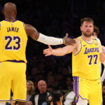 Feb 19, 2025; Los Angeles, California, USA; NBA; Los Angeles Lakers forward LeBron James (23) and guard Luka Doncic (77) celebrate after a play during the third quarter against the Charlotte Hornets at Crypto.com Arena.