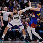 Mar 5, 2025; Denver, Colorado, USA; Sacramento Kings center Jonas Valanciunas (17) and Denver Nuggets center Nikola Jokic (15) battle for position in the second quarter at Ball Arena.