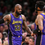 ar 8, 2025; Boston, Massachusetts, USA; Los Angeles Lakers forward LeBron James (23) high-fives guard Jordan Goodwin (30) during the second quarter of a game against the Boston Celtics at the TD Garden.
