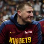 Mar 15, 2025; Denver, Colorado, USA; Denver Nuggets center Nikola Jokic (15) reacts from the bench in the second quarter against the Washington Wizards at Ball Arena. Mandatory Credit: Ron Chenoy-Imagn Images