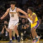 Mar 19, 2025; Los Angeles, California, USA; Los Angeles Lakers guard Bronny James (9) and Denver Nuggets forward Spencer Jones (21) battle on the court during the second half at Crypto.com Arena.
