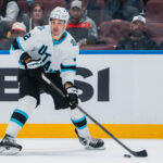 Mar 16, 2025; Vancouver, British Columbia, CAN; Utah Hockey Club forward Jack McBain (22) handles the puck against the Vancouver Canucks in the second period at Rogers Arena. Mandatory Credit: Bob Frid-Imagn Images