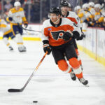 Mar 31, 2025; Philadelphia, Pennsylvania, USA; Philadelphia Flyers defenseman Cam York (8) chases the puck against the Nashville Predators in the first period at Wells Fargo Center. Mandatory Credit: Kyle Ross-Imagn Images