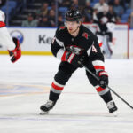 Apr 8, 2025; Buffalo, New York, USA; Buffalo Sabres defenseman Bowen Byram (4) looks to make a pass during the second period against the Carolina Hurricanes at KeyBank Center. Mandatory Credit: Timothy T. Ludwig-Imagn Images