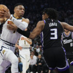 Apr 9, 2025; Sacramento, California, USA; Denver Nuggets guard Russell Westbrook (4) drives to the basket against Sacramento Kings center Isaac Jones (3) during the second quarter at Golden 1 Center.