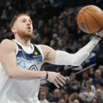 Apr 11, 2025; Minneapolis, Minnesota, USA; Minnesota Timberwolves guard Donte DiVincenzo (0) goes to the basket against the Brooklyn Nets in the fourth quarter at Target Center.