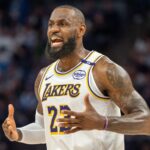 Apr 27, 2025; Minneapolis, Minnesota, USA; Los Angeles Lakers forward LeBron James (23) talks with his coach during a stoppage in play against the Minnesota Timberwolves in the second quarter during game four of first round for the 2025 NBA Playoffs at Target Center.
