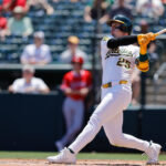 May 22, 2025; West Sacramento, California, USA; Athletics right fielder Brent Rooker (25) hits a two run home run during the first inning against the Los Angeles Angels at Sutter Health Park. Mandatory Credit: Sergio Estrada-Imagn Images